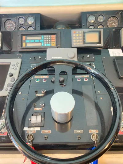 Raiders Yacht Photos Pics Control panel of a 1988 Viking 70 Cockpit Motor Yacht with steering wheel.