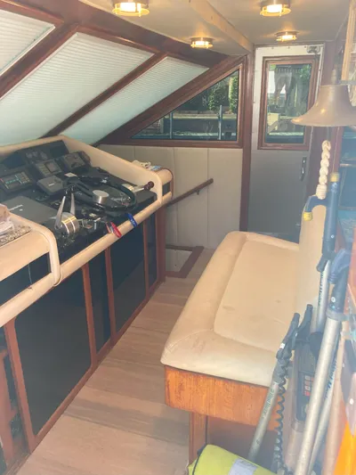 Raiders Yacht Photos Pics Interior helm station of 1988 Viking 70 Cockpit Motor Yacht with seating and control panel.