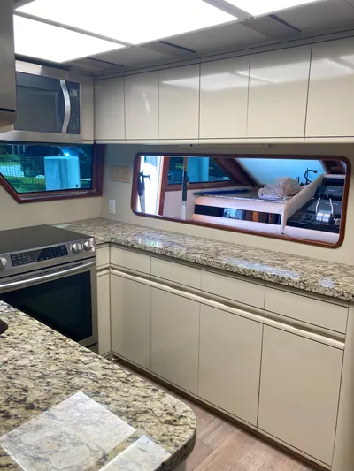 Raiders Yacht Photos Pics Modern kitchen in 1988 Viking 70 Cockpit Motor Yacht with granite countertops.