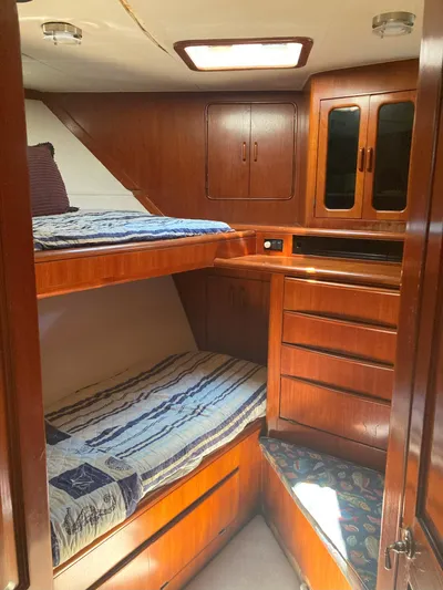 Raiders Yacht Photos Pics 1988 Viking 70 Cockpit Motor Yacht cabin with wooden bunk beds and storage.