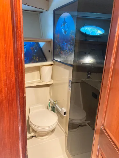 Raiders Yacht Photos Pics 1988 Viking 70 Cockpit Motor Yacht bathroom with toilet and shower.