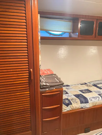 Raiders Yacht Photos Pics Interior cabin of 1988 Viking 70 Cockpit Motor Yacht with wooden storage and bed.