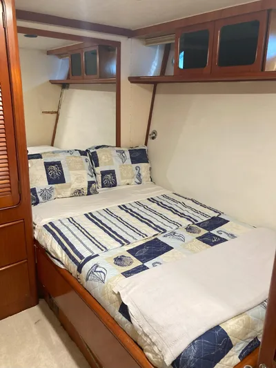 Raiders Yacht Photos Pics 1988 Viking 70 Cockpit Motor Yacht bedroom with nautical-themed bedding.
