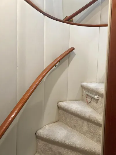 Raiders Yacht Photos Pics Staircase inside 1988 Viking 70 Cockpit Motor Yacht with wooden handrails.