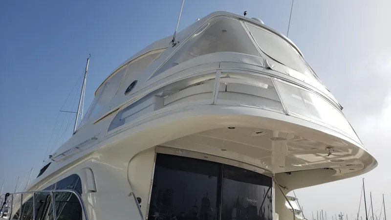 Happy Ours Yacht Photos Pics 2007 Marquis 55 LS yacht with sleek white exterior and modern design.