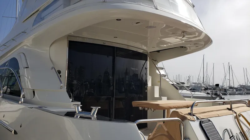 Happy Ours Yacht Photos Pics Luxury 2007 Marquis 55 LS yacht docked at marina, showcasing sleek design and spacious deck.