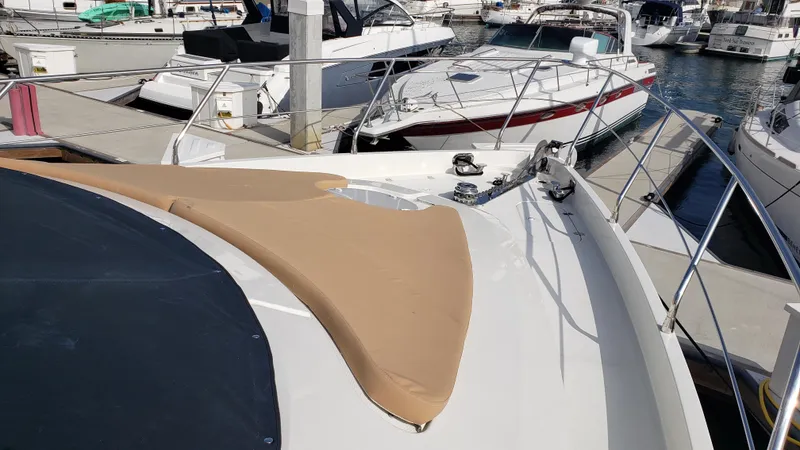 Happy Ours Yacht Photos Pics 2007 Marquis 55 LS yacht docked at a marina with other boats.