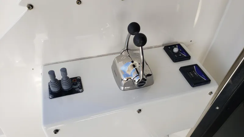 Happy Ours Yacht Photos Pics Control panel of a 2007 Marquis 55 LS yacht with throttle and joystick controls.