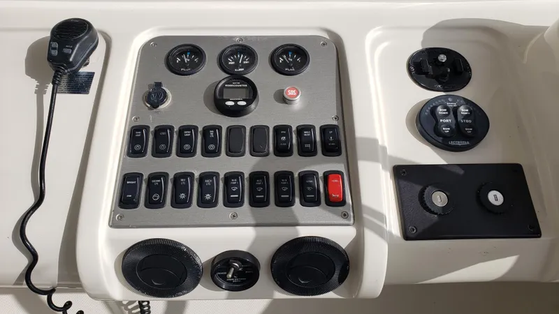 Happy Ours Yacht Photos Pics Control panel of a 2007 Marquis 55 LS yacht with various switches and gauges.