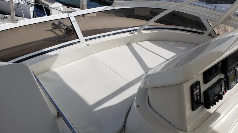 Happy Ours Yacht Photos Pics 2007 Marquis 55 LS yacht deck with cushioned seating and control panel.