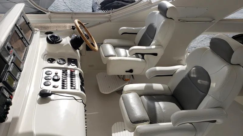 Happy Ours Yacht Photos Pics 2007 Marquis 55 LS yacht cockpit with dual leather seats and control panel.