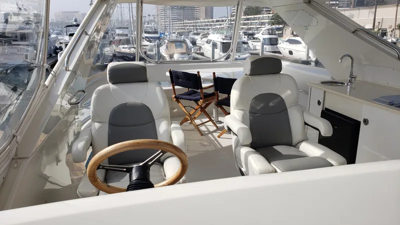 Happy Ours Yacht Photos Pics Luxury interior of 2007 Marquis 55 LS yacht with helm and seating area.
