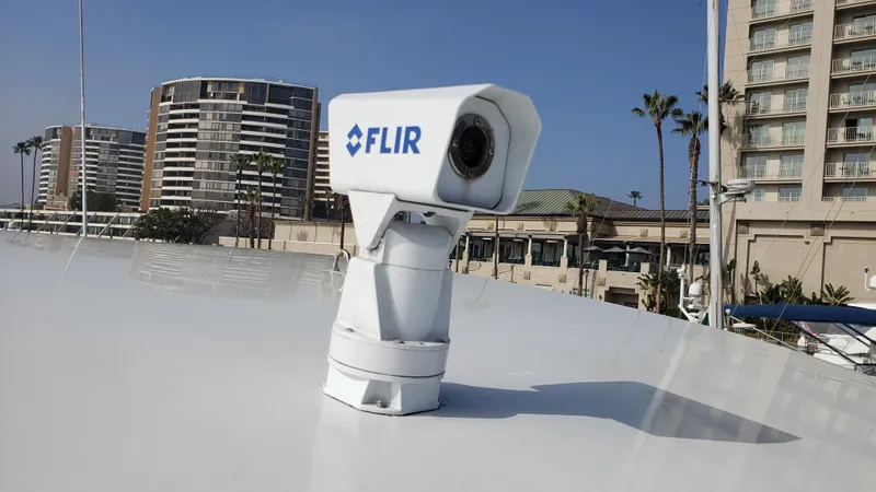 Happy Ours Yacht Photos Pics FLIR camera mounted on a 2007 Marquis 55 LS yacht, with urban buildings in the background.