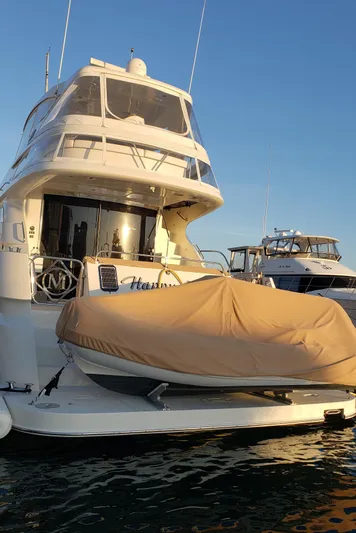 Happy Ours Yacht Photos Pics 2007 Marquis 55 LS yacht docked with covered tender at sunset.