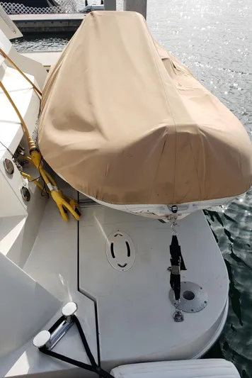 Happy Ours Yacht Photos Pics 2007 Marquis 55 LS yacht with covered dinghy on deck.