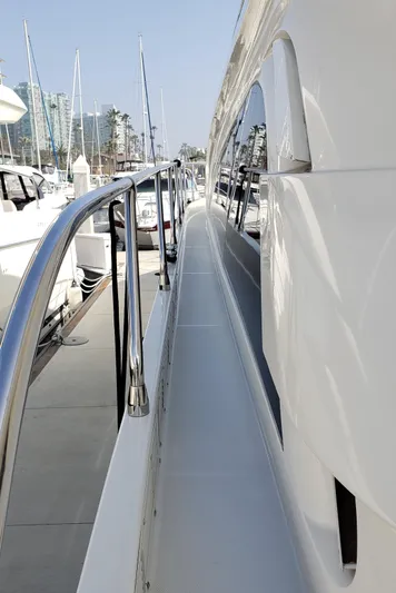 Happy Ours Yacht Photos Pics Side view of a 2007 Marquis 55 LS yacht docked at a marina.