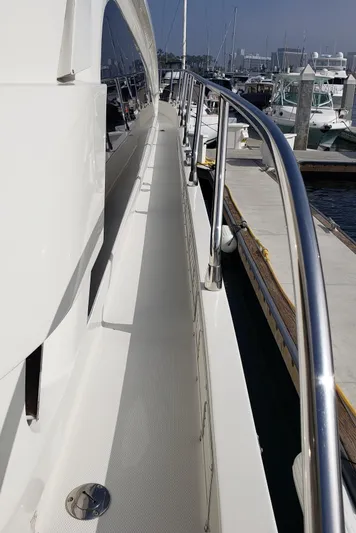 Happy Ours Yacht Photos Pics 2007 Marquis 55 LS yacht deck with stainless steel railing at marina.