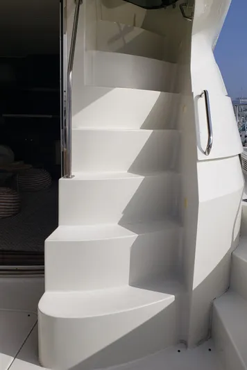 Happy Ours Yacht Photos Pics Staircase on a 2007 Marquis 55 LS yacht, featuring sleek white design and stainless steel handrail.