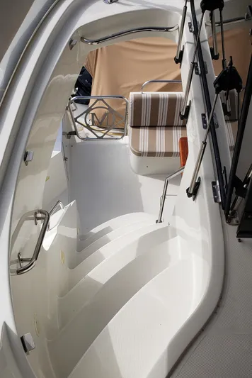 Happy Ours Yacht Photos Pics Staircase on 2007 Marquis 55 LS yacht with striped seating and sleek design.