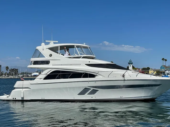 Happy Ours Yacht Photos Pics 2007 Marquis 55 LS yacht on calm water under clear blue sky.