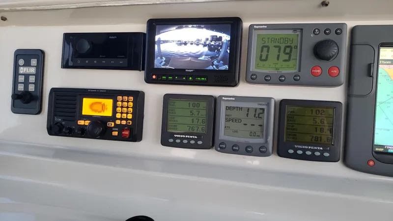 Happy Ours Yacht Photos Pics Control panel of a 2007 Marquis 55 LS yacht with navigation and communication instruments.