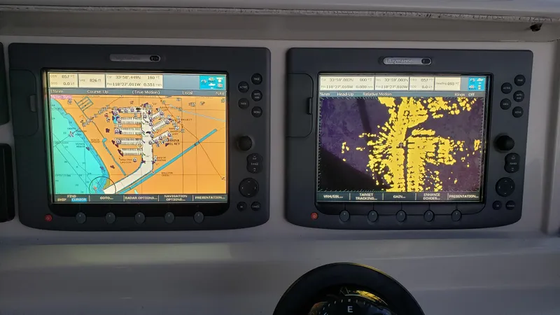 Happy Ours Yacht Photos Pics Navigation screens on a 2007 Marquis 55 LS yacht displaying maps and radar data.