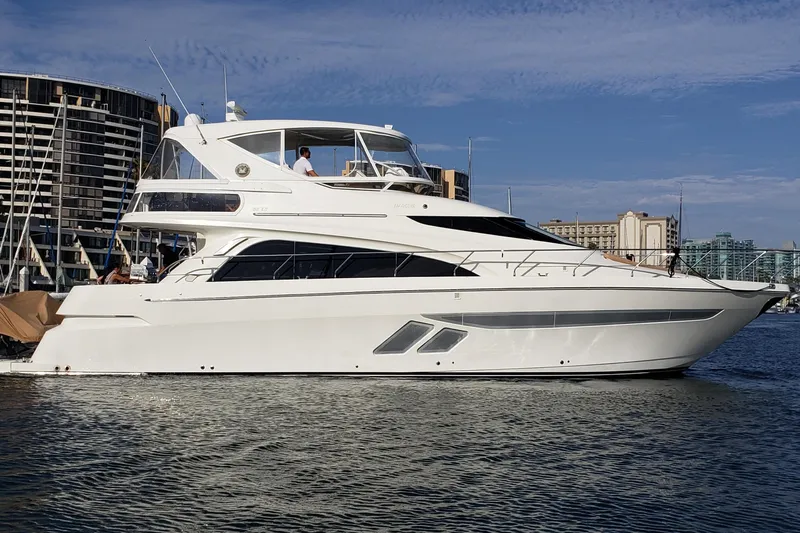 Happy Ours Yacht Photos Pics 2007 Marquis 55 LS yacht docked in a marina with cityscape background.