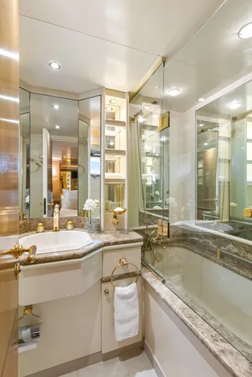 Mistress Yacht Photos Pics Luxurious bathroom in a 1991 Benetti 46m yacht with elegant fixtures and marble accents.
