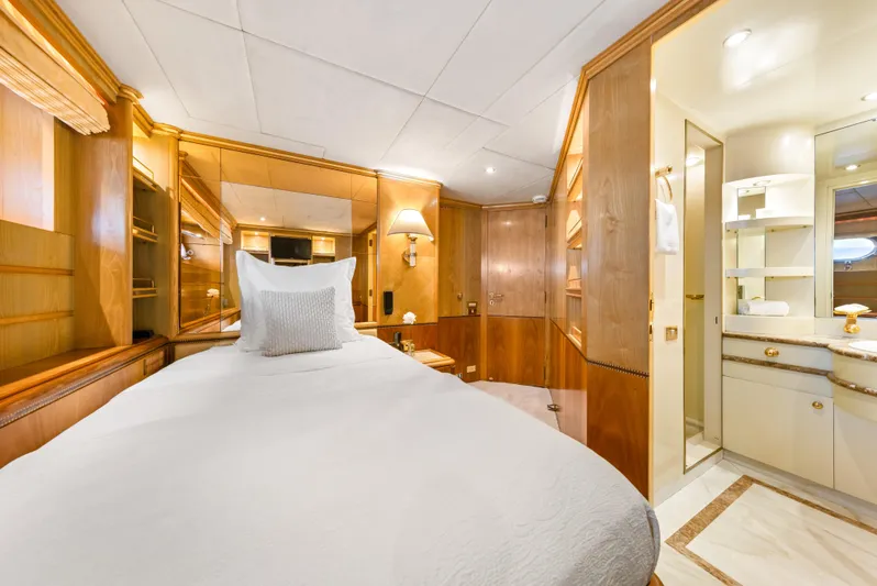 Mistress Yacht Photos Pics Luxurious cabin interior of 1991 Benetti 46m yacht with elegant wood paneling and ensuite bathroom.