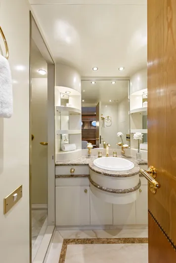 Mistress Yacht Photos Pics Luxurious bathroom on 1991 Benetti 46m yacht with elegant fixtures and mirrored cabinets.
