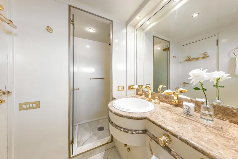Mistress Yacht Photos Pics Luxurious bathroom on 1991 Benetti 46m yacht with marble countertop and gold fixtures.