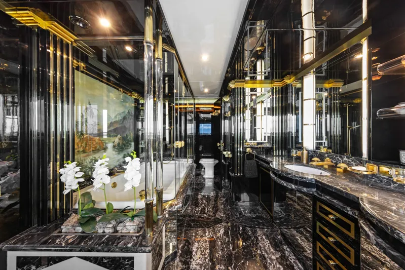 Mistress Yacht Photos Pics Luxurious bathroom on a 1991 Benetti 46m yacht with marble and gold accents.