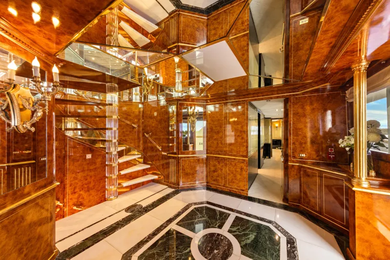 Mistress Yacht Photos Pics Luxurious interior of 1991 Benetti 46m yacht with elegant wood paneling and mirrored accents.