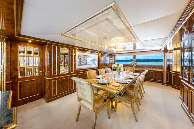 Mistress Yacht Photos Pics Luxurious dining area on a 1991 Benetti 46m yacht with elegant wood paneling.