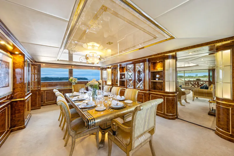 Mistress Yacht Photos Pics Luxurious dining area on a 1991 Benetti 46m yacht, featuring elegant decor and ocean views.