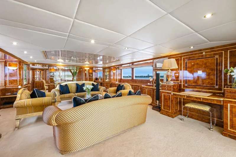Mistress Yacht Photos Pics Luxurious interior of a 1991 Benetti 46m yacht with elegant wood paneling and plush seating.