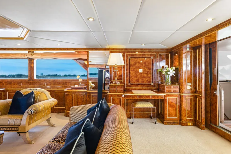 Mistress Yacht Photos Pics Luxurious interior of a 1991 Benetti 46m yacht with elegant wood paneling and plush seating.