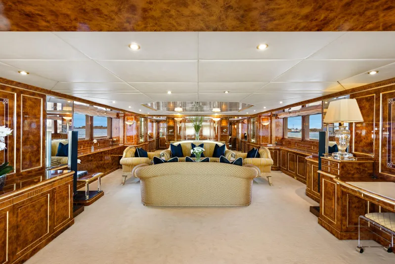 Mistress Yacht Photos Pics Luxurious interior of a 1991 Benetti 46m yacht with elegant wood paneling and plush seating.