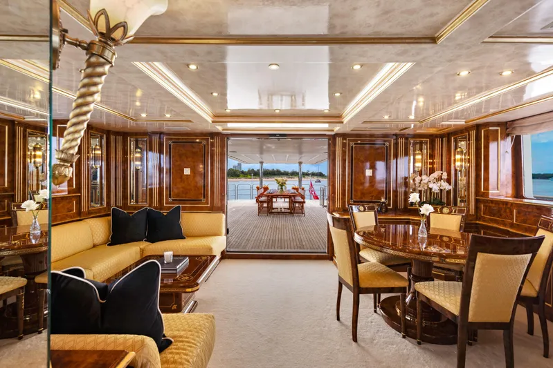 Mistress Yacht Photos Pics Luxurious interior of 1991 Benetti 46m yacht with elegant wood finishes and plush seating.