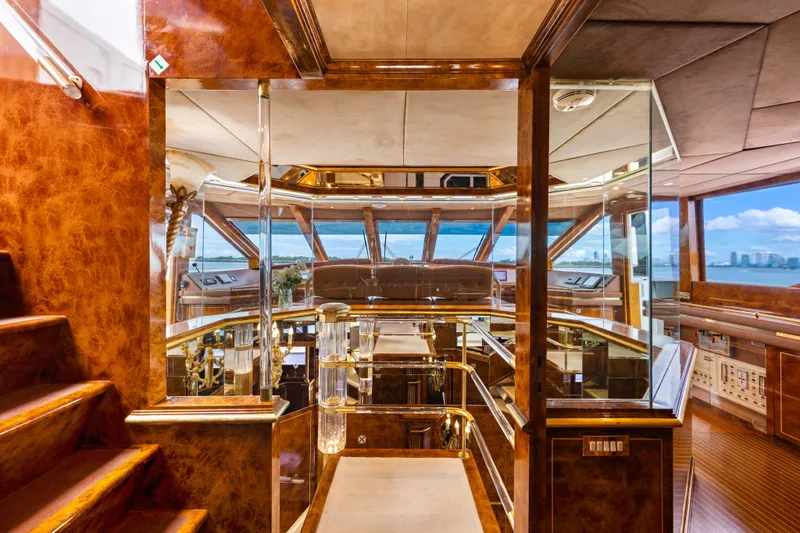 Mistress Yacht Photos Pics Luxurious interior of a 1991 Benetti 46m yacht with elegant wood finishes and panoramic windows.