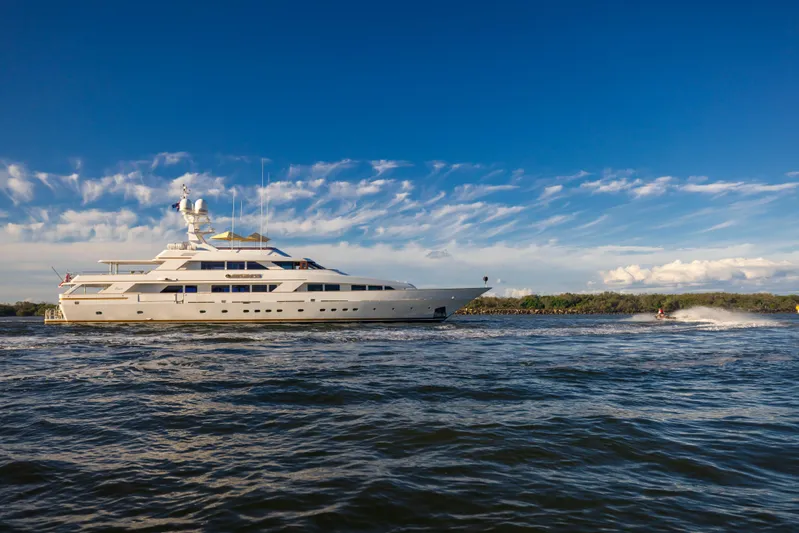 Mistress Yacht Photos Pics Luxury Benetti 46m yacht cruising on open water under a clear blue sky.