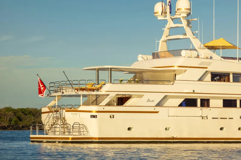Mistress Yacht Photos Pics Luxury Benetti 46m yacht from 1991 on calm waters, featuring elegant design and spacious decks.