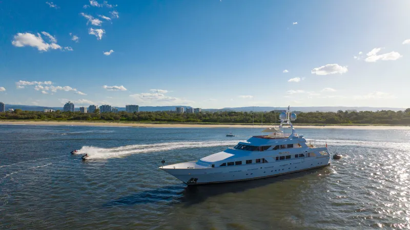 Mistress Yacht Photos Pics Luxurious 1991 Benetti 46m yacht cruising on a sunny day near the coastline.