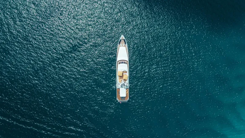 Mistress Yacht Photos Pics Aerial view of 1991 Benetti 46m yacht on serene blue ocean waters.