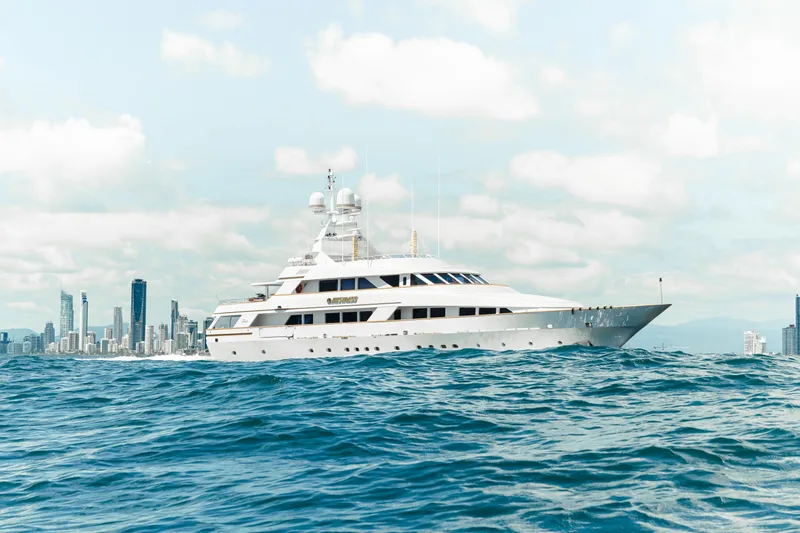 Mistress Yacht Photos Pics Luxury Benetti 46m yacht cruising near city skyline, 1991 model.