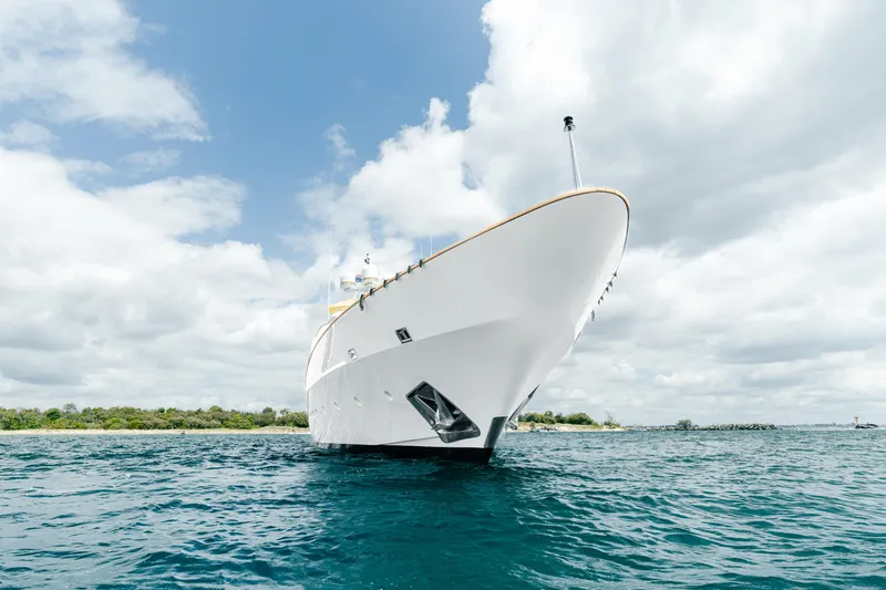 Mistress Yacht Photos Pics Luxury Benetti 46m yacht from 1991 on open water, under a cloudy sky.
