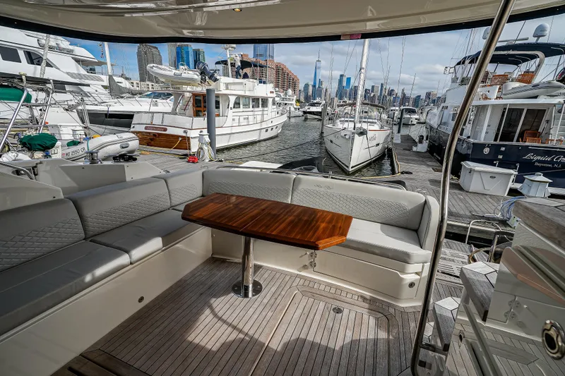 Yan Ge Yacht Photos Pics Luxurious 2018 Sea Ray L590 Fly yacht interior with elegant seating and wooden table in marina.