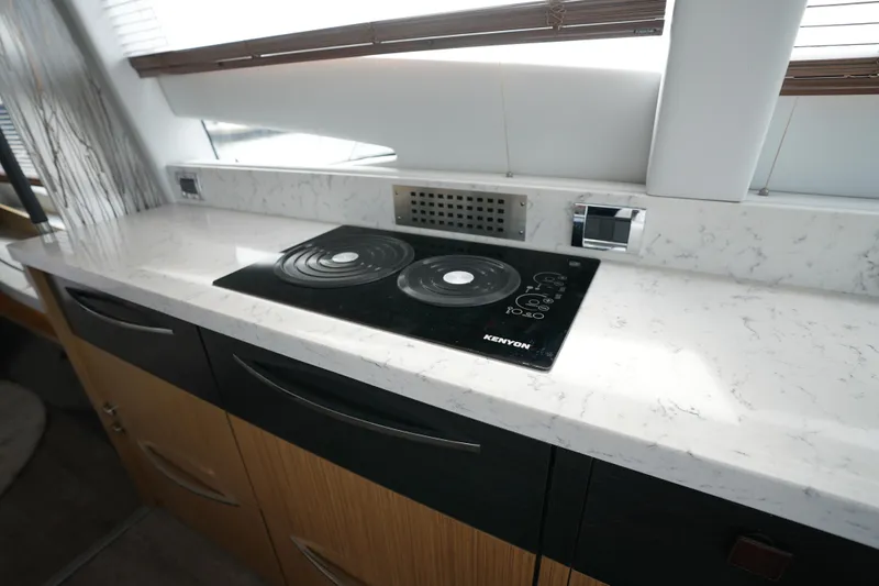 Yan Ge Yacht Photos Pics Modern kitchen in 2018 Sea Ray L590 Fly yacht with marble countertop and Kenyon cooktop.