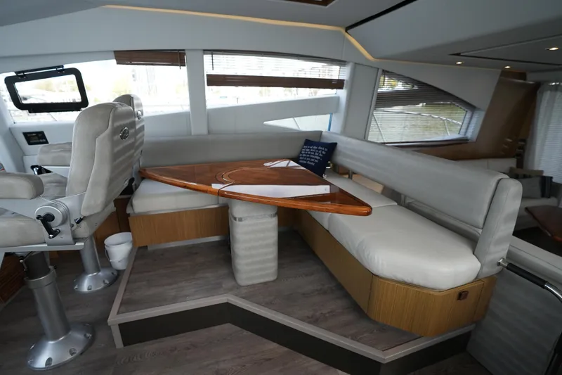 Yan Ge Yacht Photos Pics Luxurious interior of 2018 Sea Ray L590 Fly yacht with plush seating and wooden table.