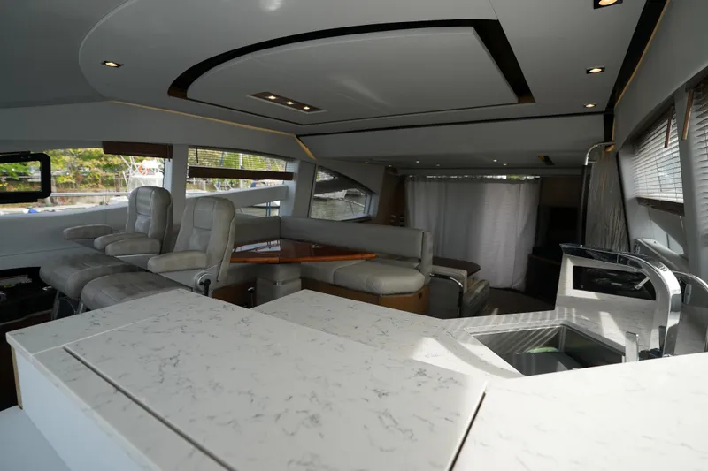Yan Ge Yacht Photos Pics Luxurious interior of 2018 Sea Ray L590 Fly yacht with modern seating and sleek design.